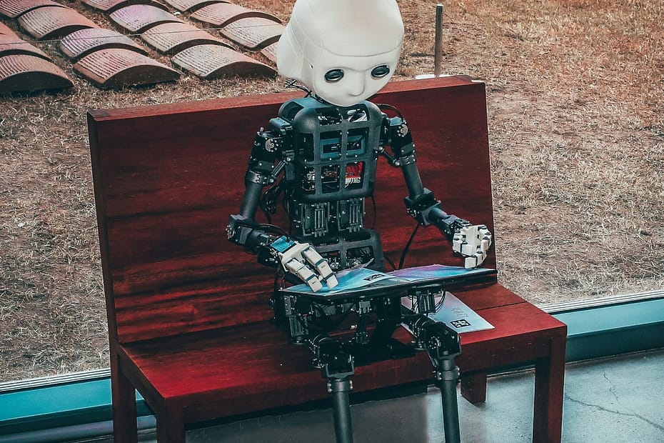 black and white robot toy on red wooden table